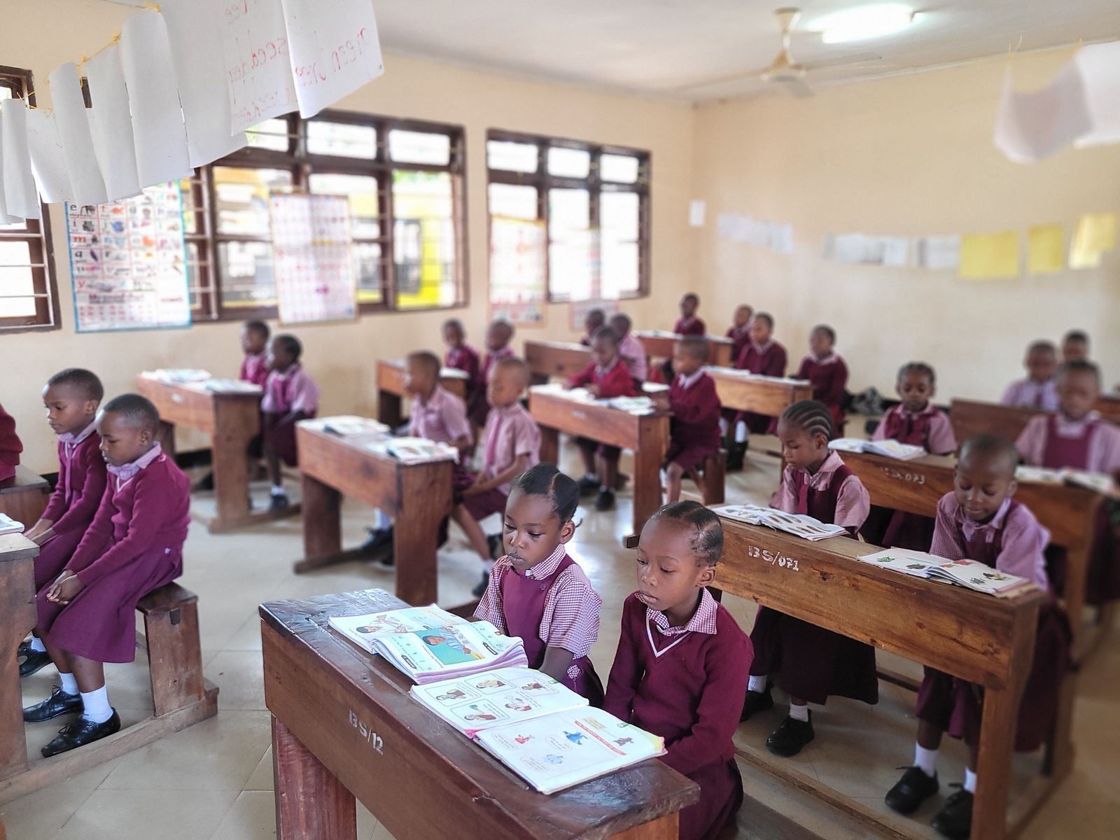 Young pupils reading at their desks