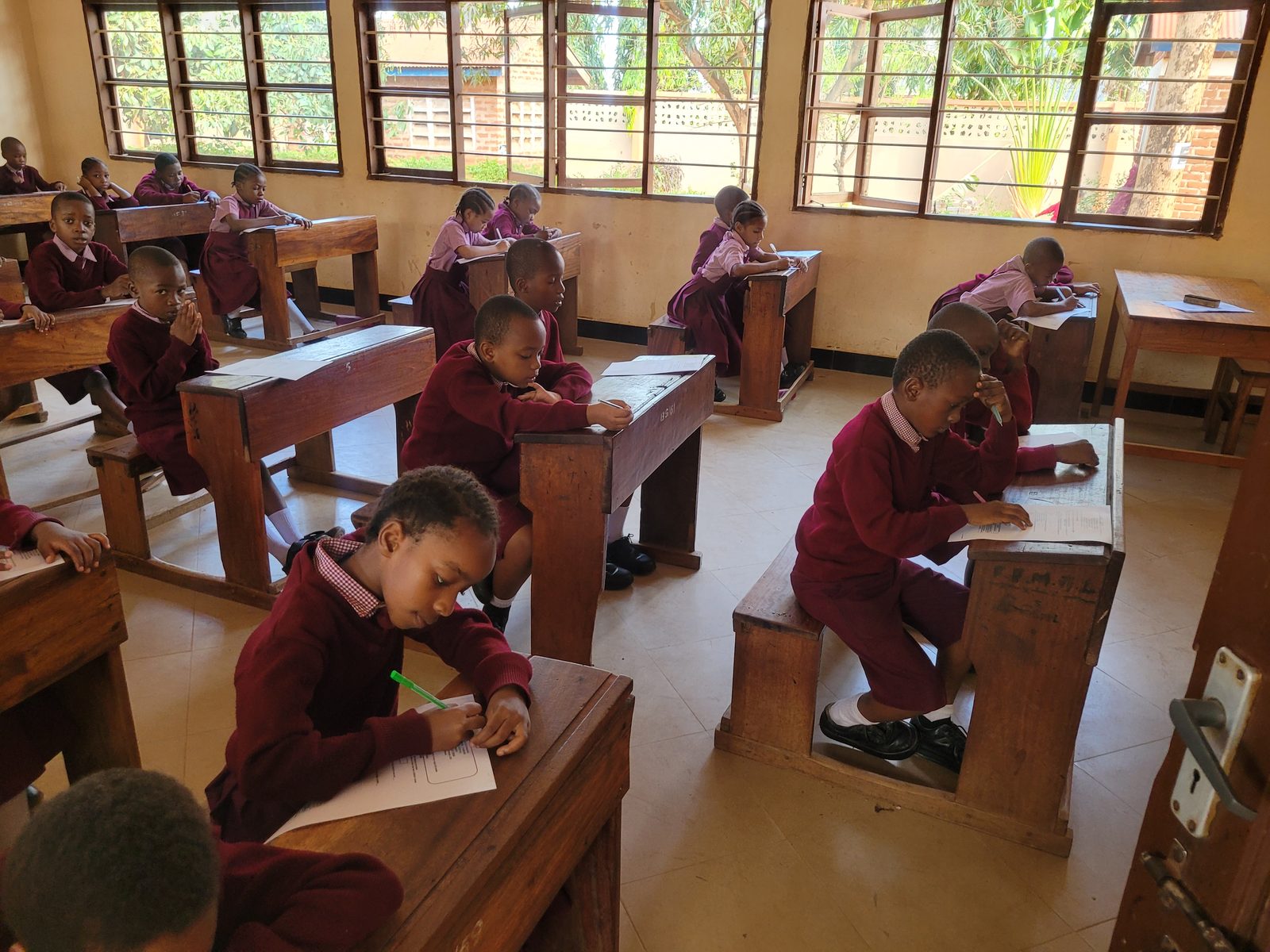 Pupils writing at their desks during a test