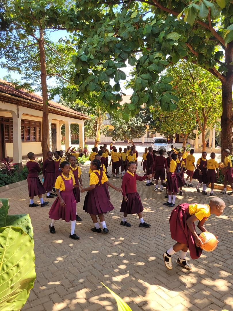 Pupils playing together in the shade at break time