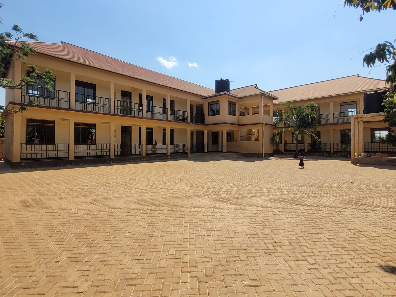 The main two-storey Bensal school building and its paved compound